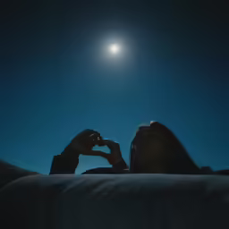 the woman lying down is taking a photograph