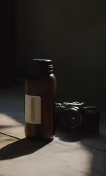 a bottle with a camera next to it