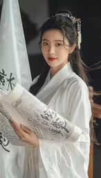 a girl in white clothes reading a large scroll,a girl holding a chinese newspaper looking at the camera