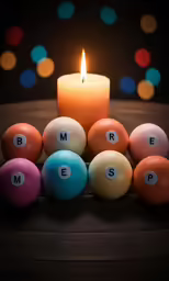 a candle is in between eight balls and a word is spelled with small letters