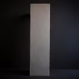 an artistic grey rectangular object standing against a black background