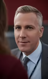 a man with white hair in business attire