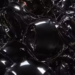 a large pile of shiny black balls or rims