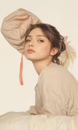 a young girl is laying on her bed