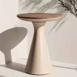 a round table sitting next to a plant