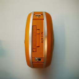 a close up of an orange object on a white wall