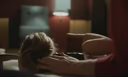a girl laying on her stomach in bed
