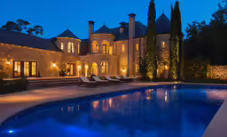the house has an outdoor pool and lawn chairs