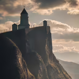 a church tower on top of a mountain with barbed wire over it