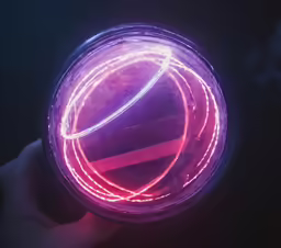 a person holding a purple object with red and white lines on it