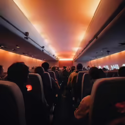 people sit in rows on an airplane