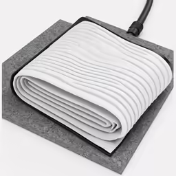 a vacuum that is on a blanket next to a flat surface