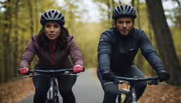 a couple of people riding on bikes through the forest