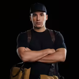 a male in a black shirt is wearing a brown bag