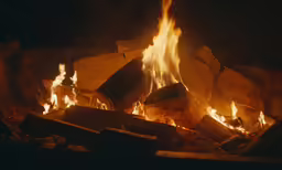 a fire blazing inside a brick fire place