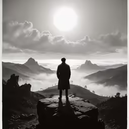 a man looks at the mountains in the distance