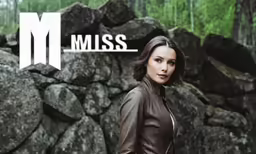 a woman posing for a photo by some rocks