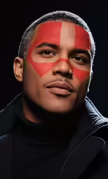 a man with an orange and red face paint on his face