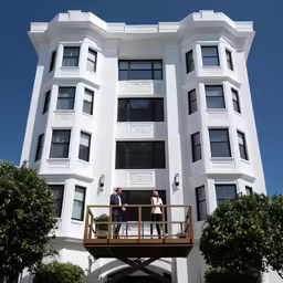 a man and woman are on the outside of an elaborate building