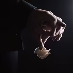 a man in a business suit is holding something with his hands