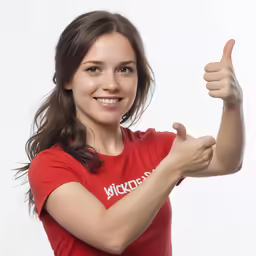 a woman making a thumbs up and holding something in one hand