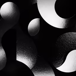 black and white photo of circular shapes in the dark