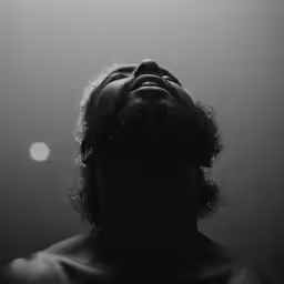 man gazing up in the sky on top of him