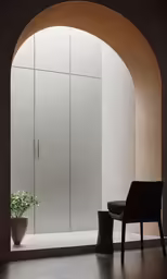 an arched entrance with chairs and vases