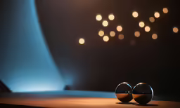 two balls on a table facing each other and some lights above them