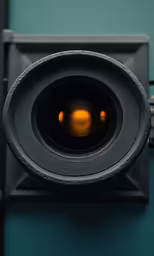 the lens is visible of the camera on a wall
