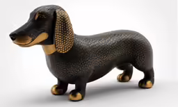 a dog figurine with gold and brown patterns