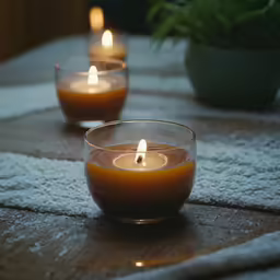 three candles are lit on a table