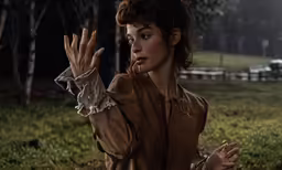 a girl holding a hand out to something with a hand up