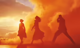 silhouettes of three people walking past an orange background