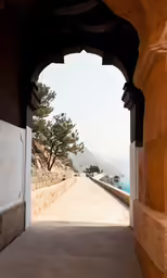 the walkway between two buildings leads to a picturesque view of the ocean