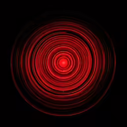 a close up of a red light in the dark