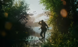 a man taking a photo of a body of water near trees