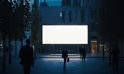 people walking around with the light on a large white screen