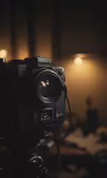 a small video camera on a tripod in the dark