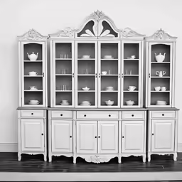 an old white china cabinet with many shelves
