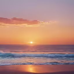a sun is rising over the ocean on a beach