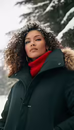 a woman in a green coat and red scarf