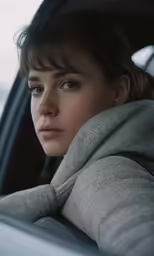 a close up of a woman in a car looking to the side