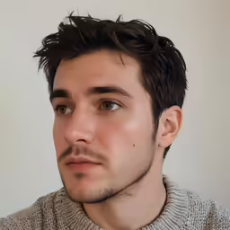 a close up of a young man with short hair