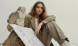 a woman sitting on top of a white and black chair