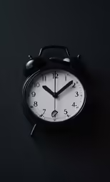 an alarm clock showing 5 55 as it lays on a surface