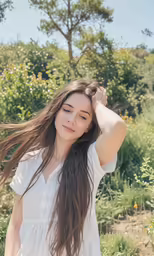 a woman with long hair and a white shirt is posing
