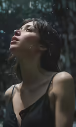 the woman is looking at something that she is holding