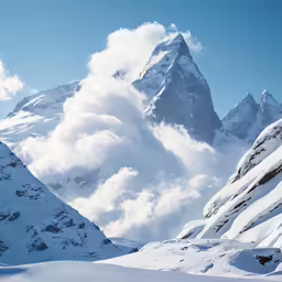 a mountain with snow capped mountains behind it