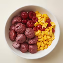 a white bowl filled with fruits and vegetables